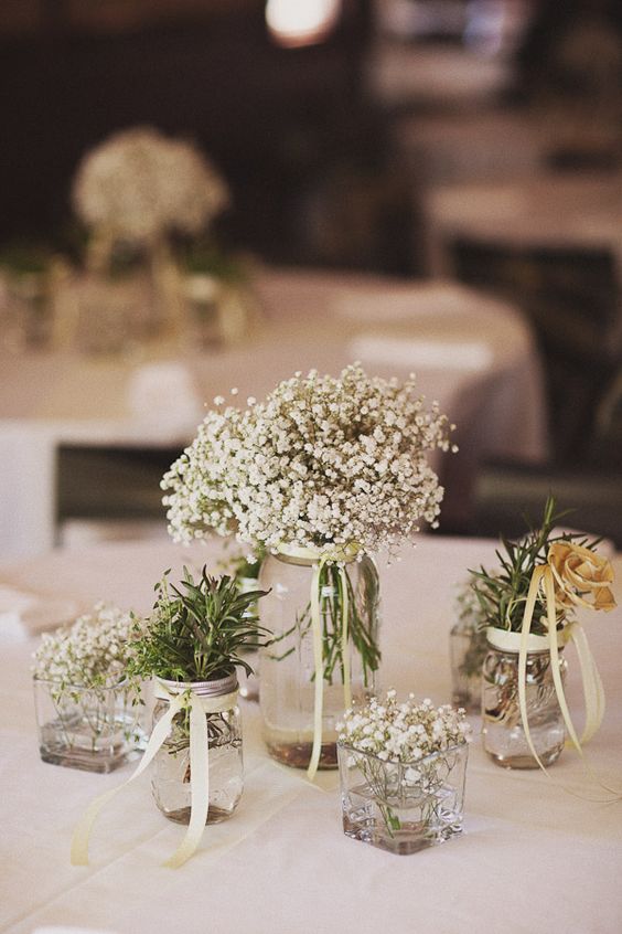 Babys breath centerpiece with mixed glass jar bud vases 