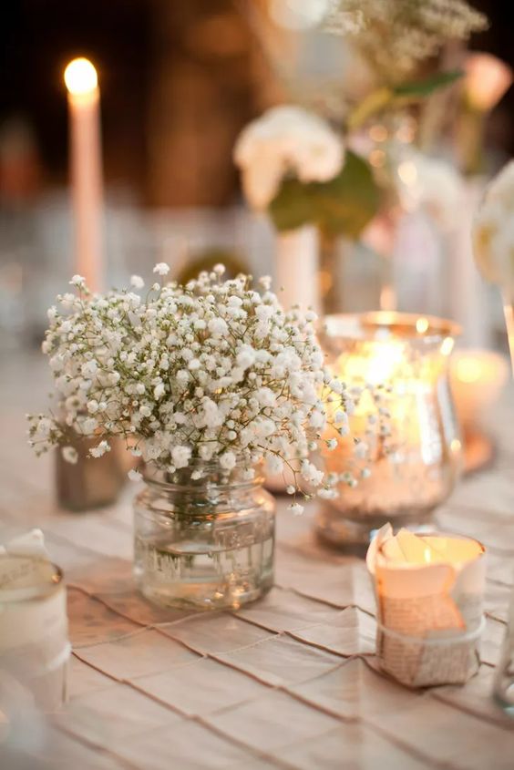 Babys Breath Bud Vase surrounded by votive candles